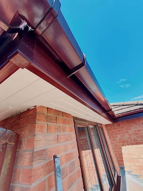 New brown fascia, guttering and white soffits under a tiled roof