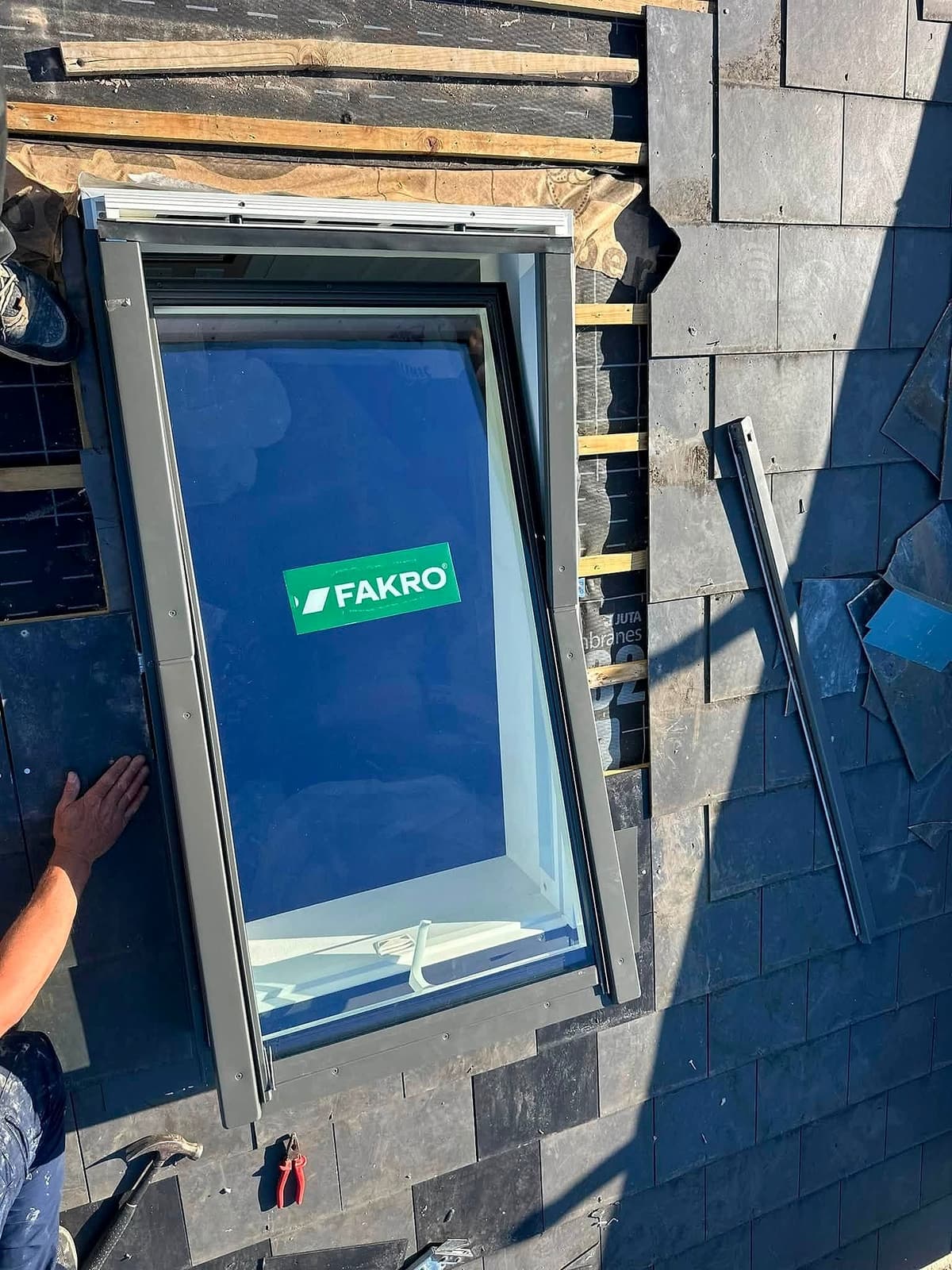 Roof window being fitted into a slate roof