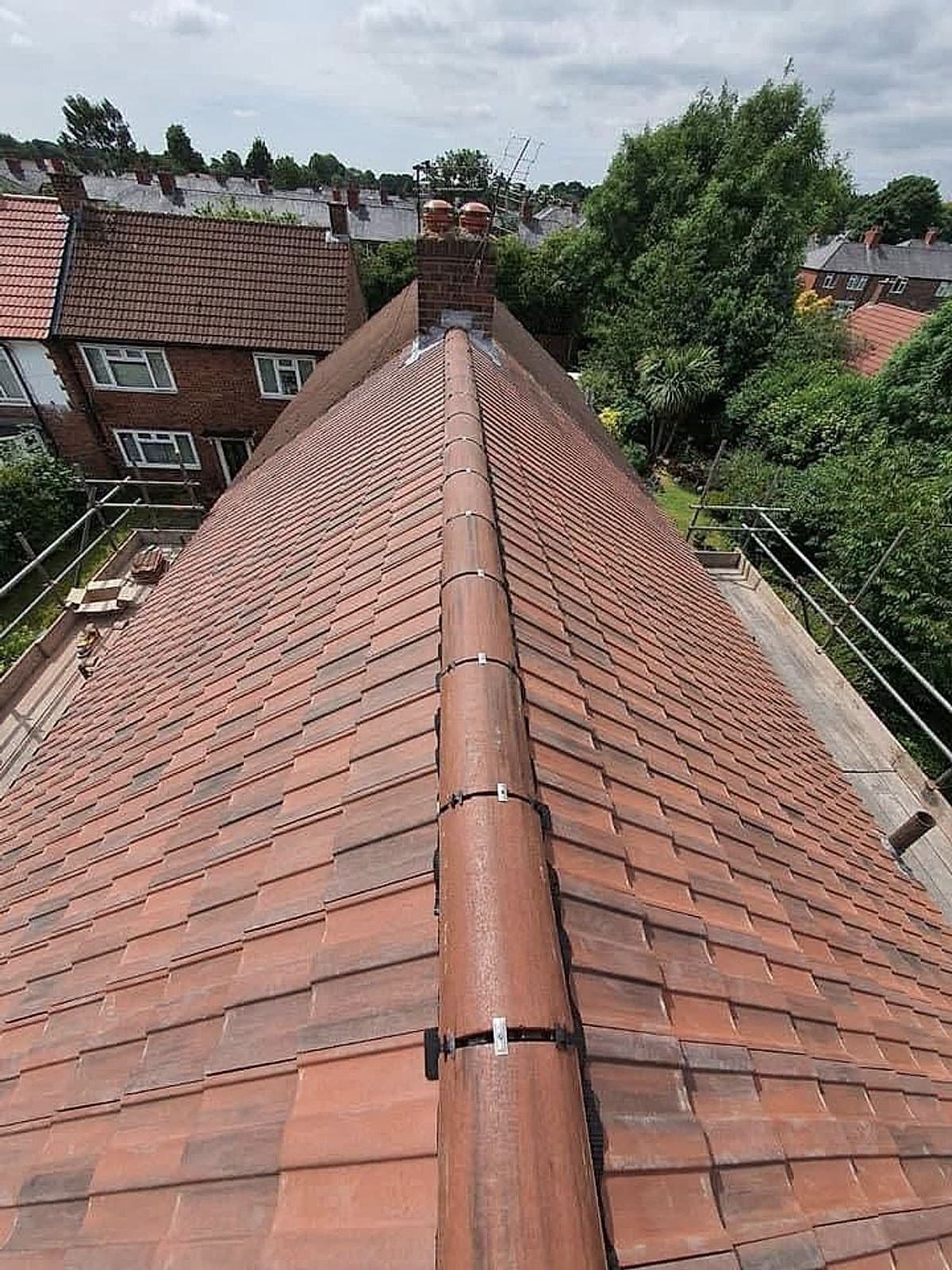 Roof re-laid in new red clay tiles with a new ridge
